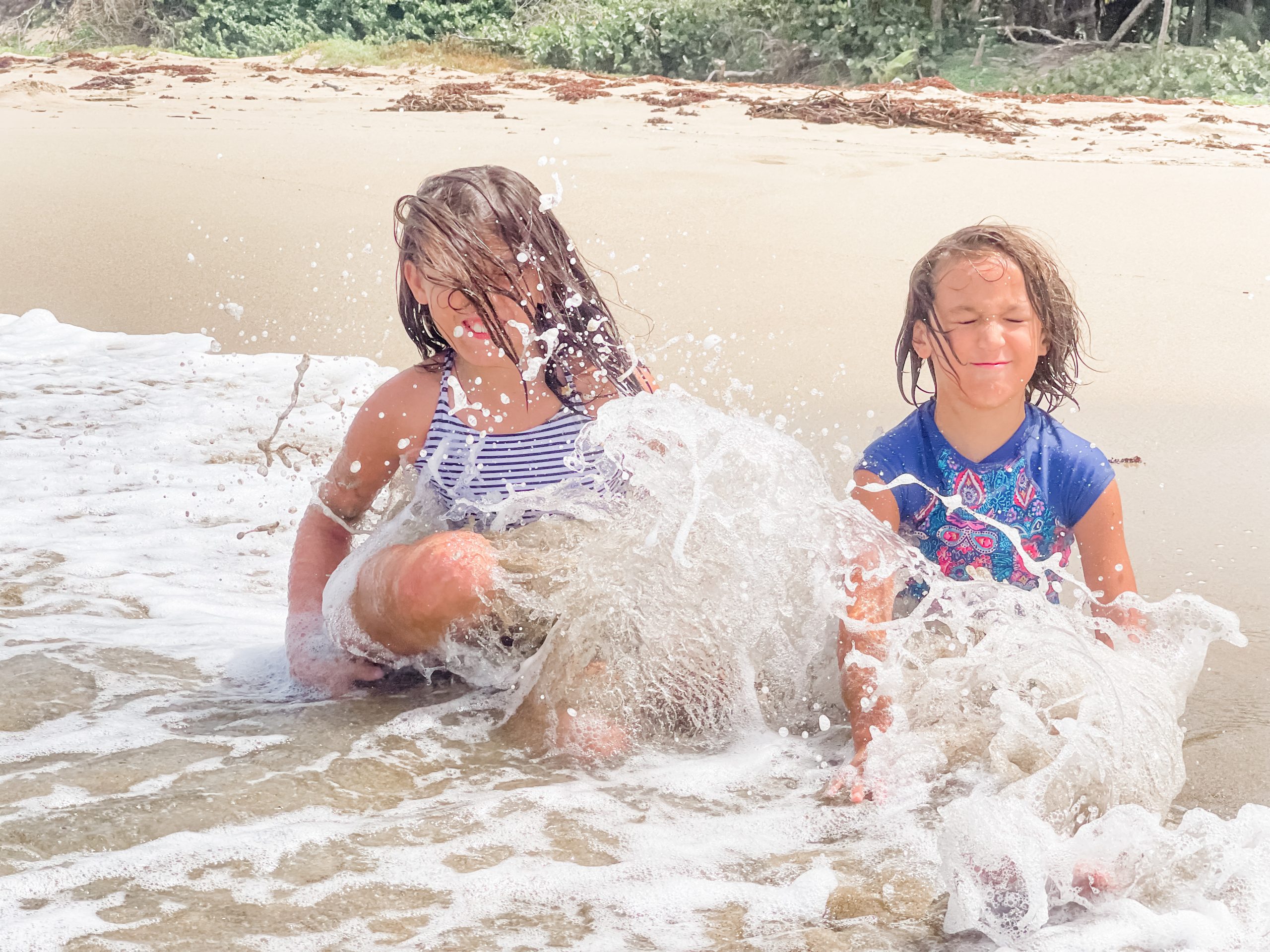 Kids being splashed by waves