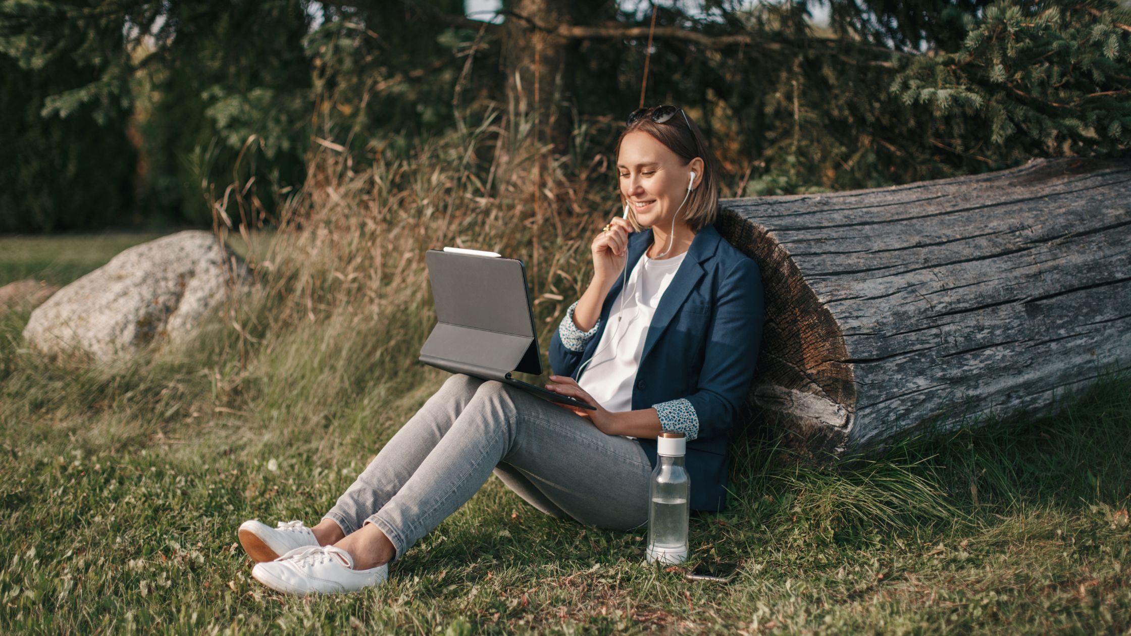 A woman working remotely while communing with nature.