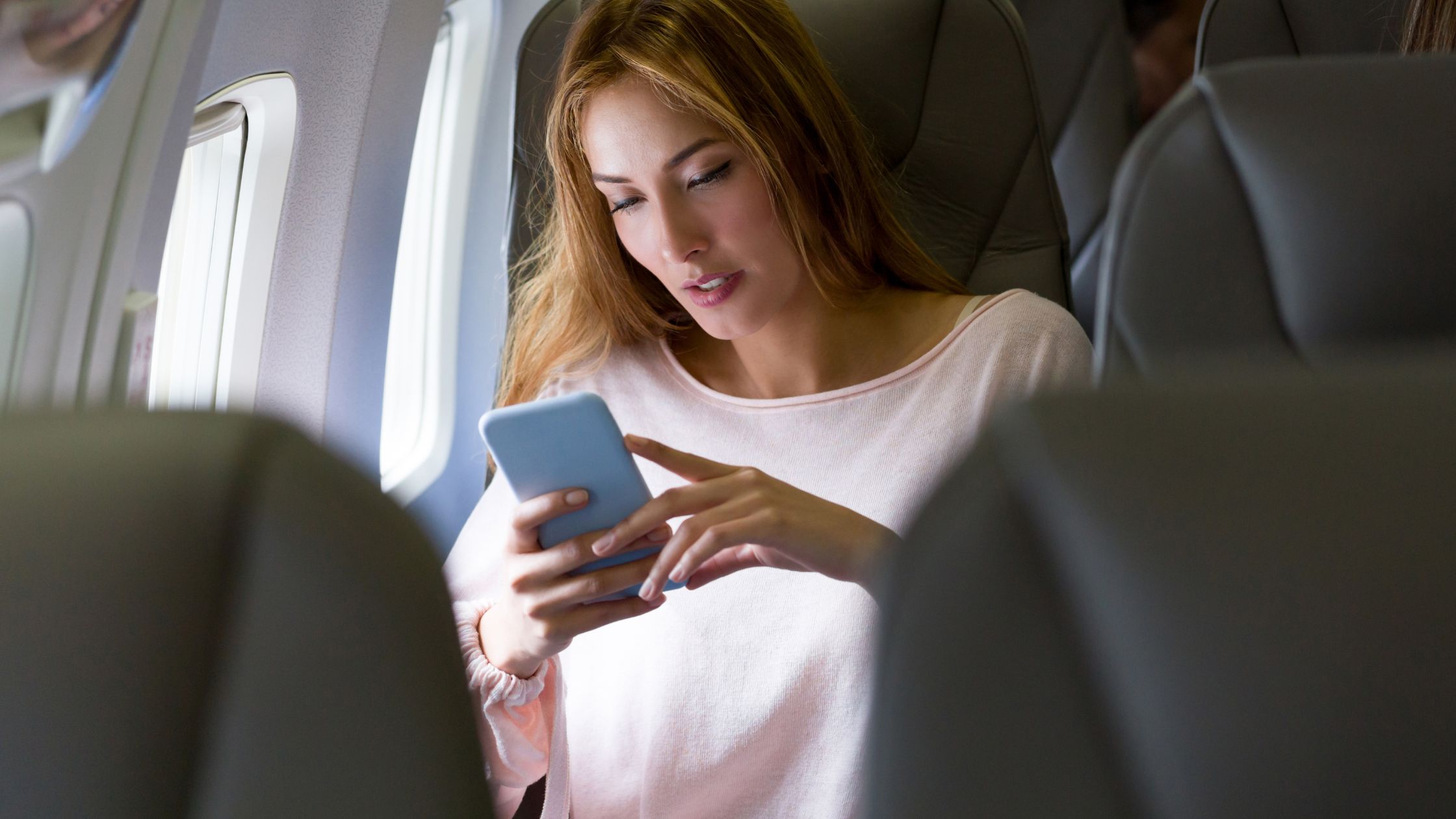 Can You Text on a Plane In-Flight? [Complete Guide] - Nomad Veronica