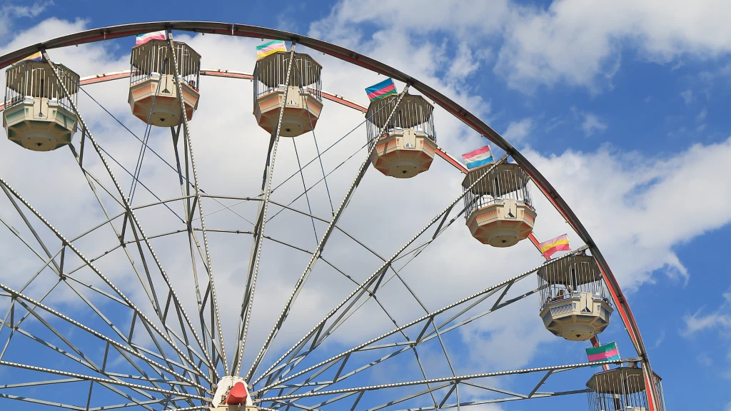 An image of a Ferris wheel under a blue sky.