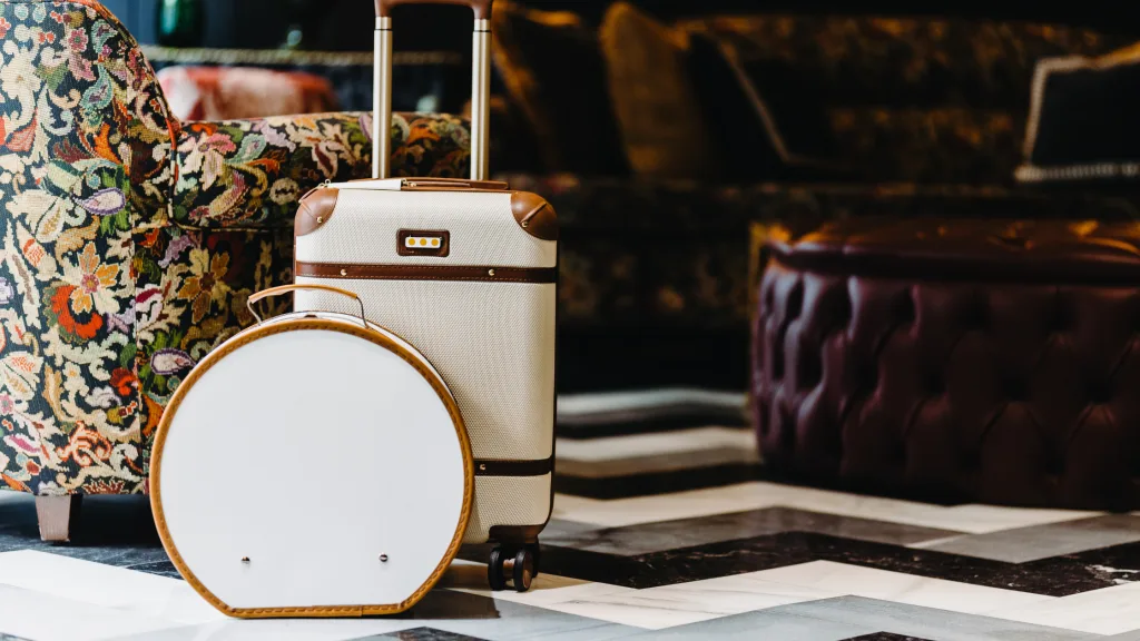 An image of a stackable luggage and a hat bag/.