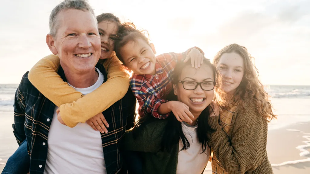 A family posing for a picture while visiting one of the best vacation spots for teens. 