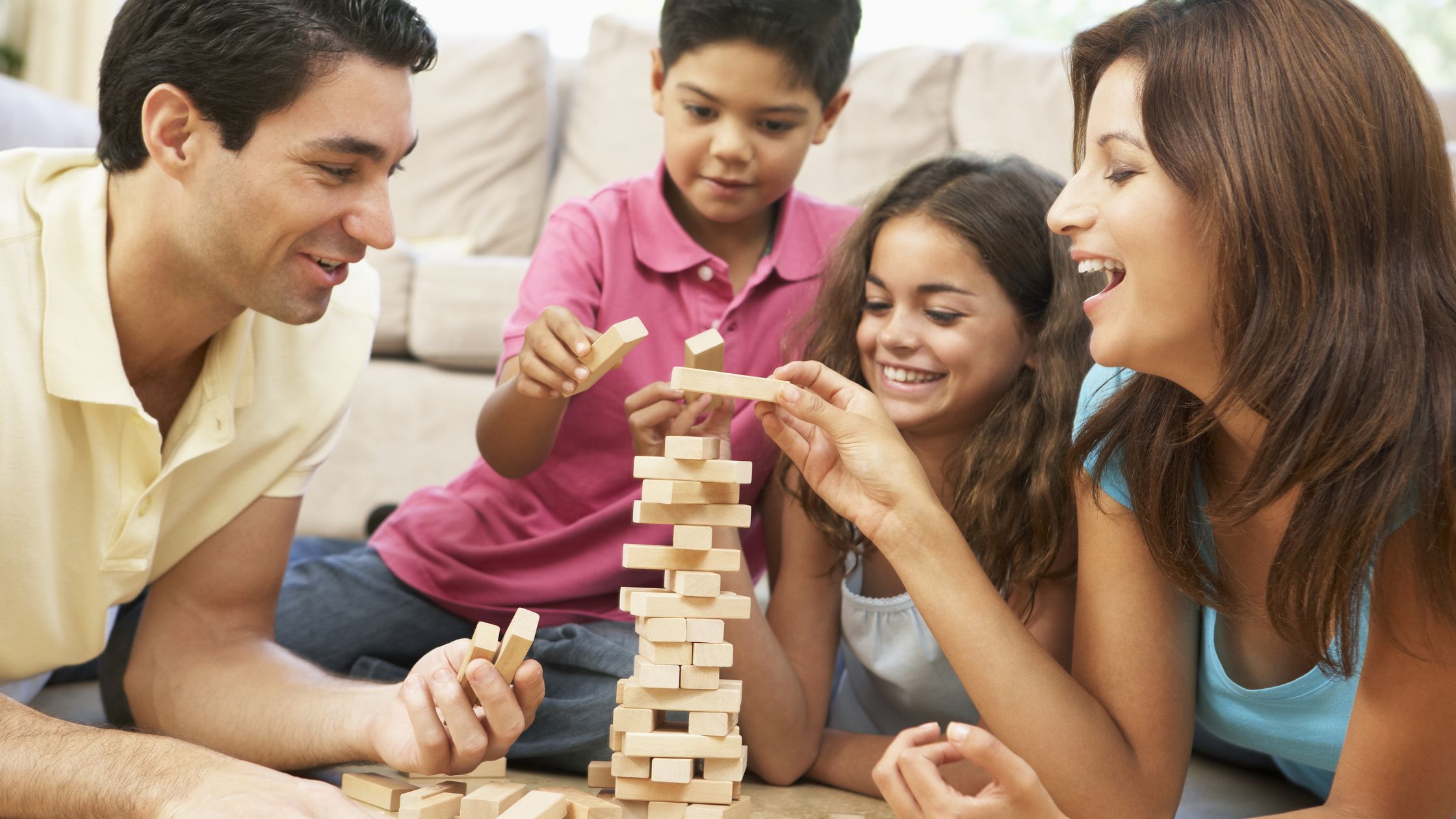 An image of a family playing Jenga for an article about "family fun on a budget."