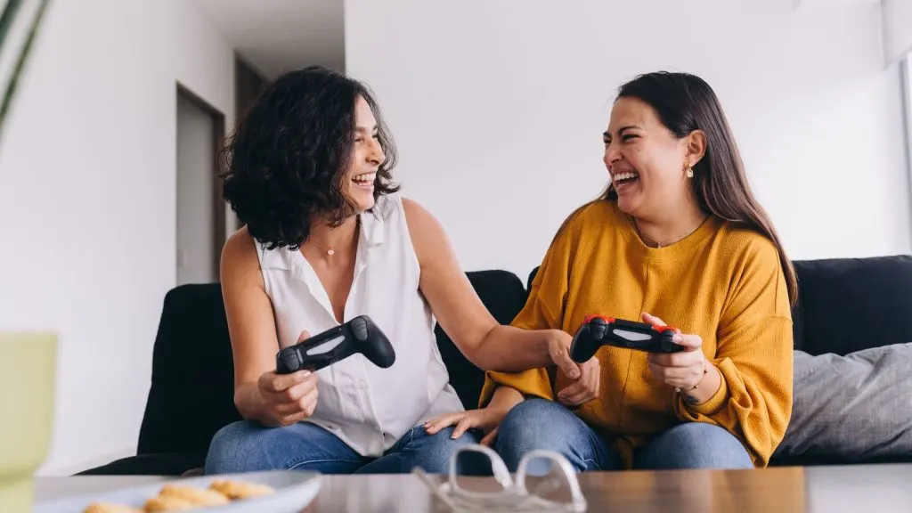 An image of a mother and daughter playing on a PS4.