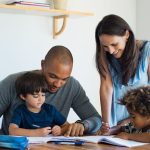 An image of parents teaching their children for an article about "parenting styles defined."