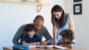 An image of parents teaching their children for an article about "parenting styles defined."