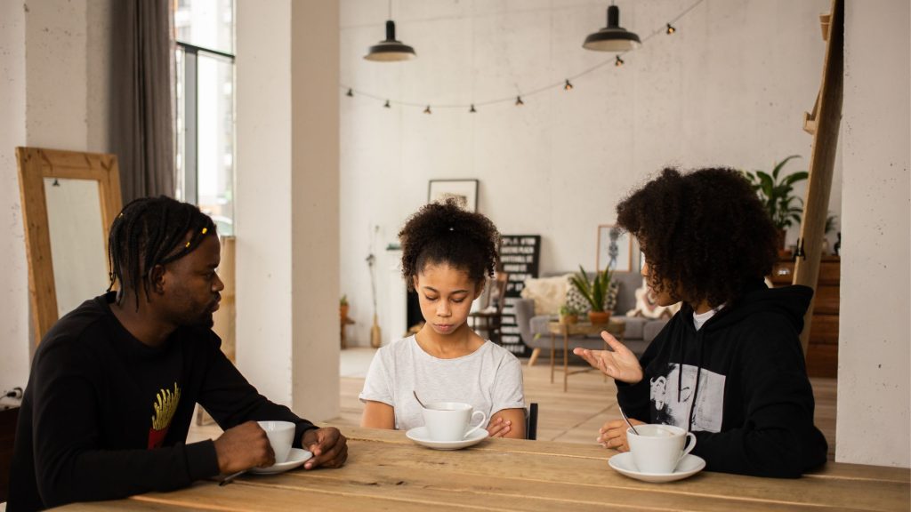 An image of parents discussing with their kid.