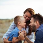 An image of parents engaging with their kid for an article about "positive parenting solutions."