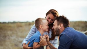 An image of parents engaging with their kid for an article about "positive parenting solutions."