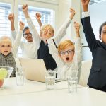 An image of kids in suits for the article about "business ideas for kids."