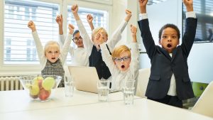 An image of kids in suits for the article about "business ideas for kids."