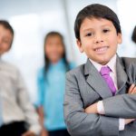 An image of children in business suits for an article about "small business ideas for kids."