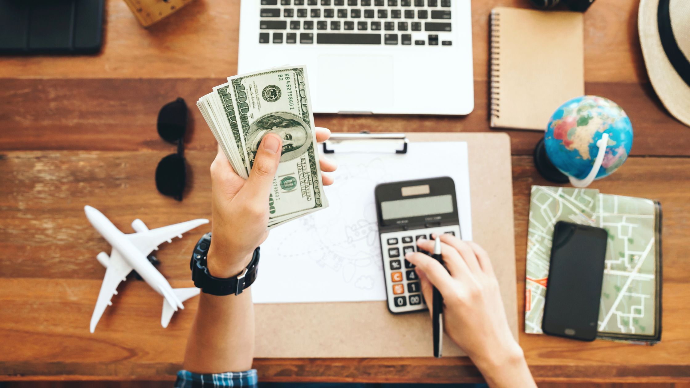 An image of a digital nomad computing their budget for an article about "budget luxury vacation."