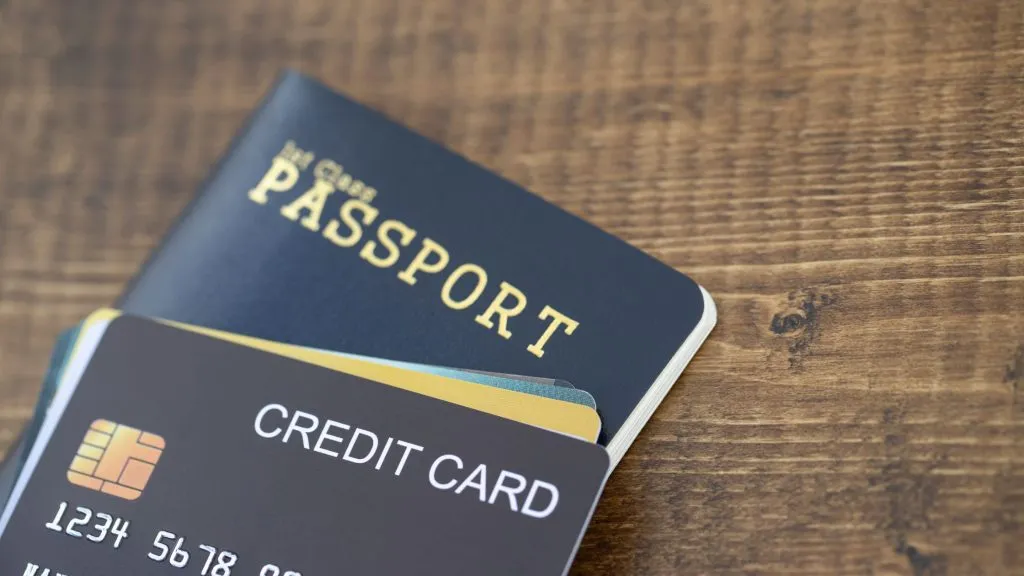 An image of a passport and credit card of a traveler.