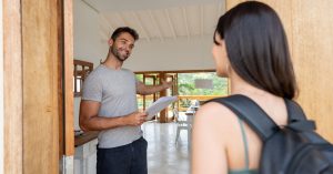An image of an Airbnb host welcoming his guest for an article about Airbnb profile examples.