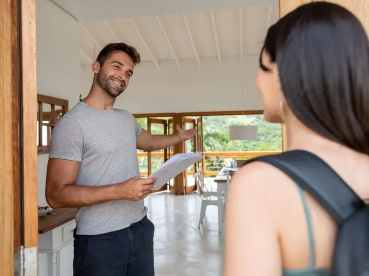 An image of an Airbnb host welcoming his guest for an article about Airbnb profile examples.