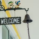 an image of a welcome sign hanged with a windchime