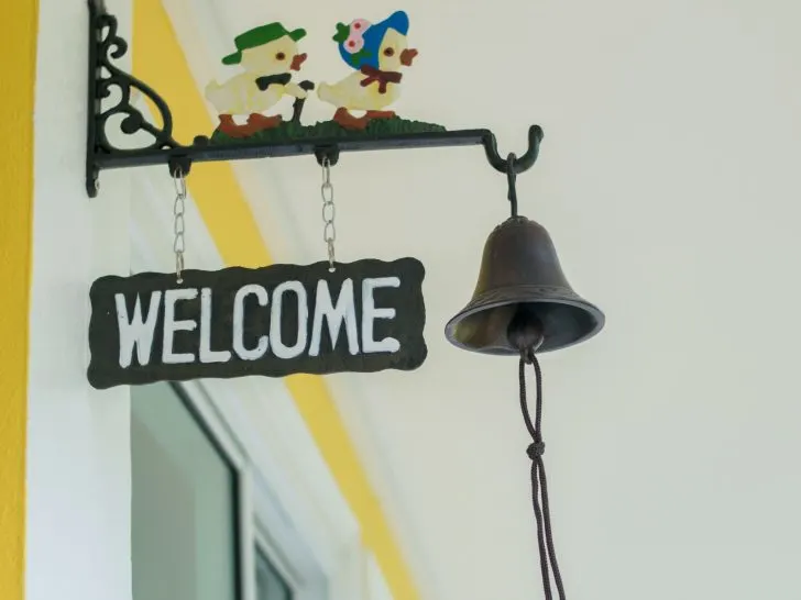 an image of a welcome sign hanged with a windchime