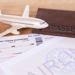 An image of a model plane and boarding passes for an article about "do airline miles expire."