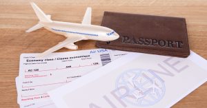 An image of a model plane and boarding passes for an article about "do airline miles expire."