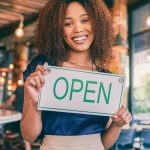An image of a host opening her property for guests for an article about how much to start Airbnb.