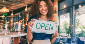 An image of a host opening her property for guests for an article about how much to start Airbnb.