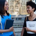 An image of young adults holding financial books for an article about the best books on financial independence.