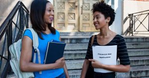 An image of young adults holding financial books for an article about the best books on financial independence.