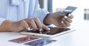 An image of a male traveler checking his reward points balance for an article about what is travel hacking?