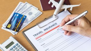 An image of a traveler signing an insurance form for an article about the best travel insurance.