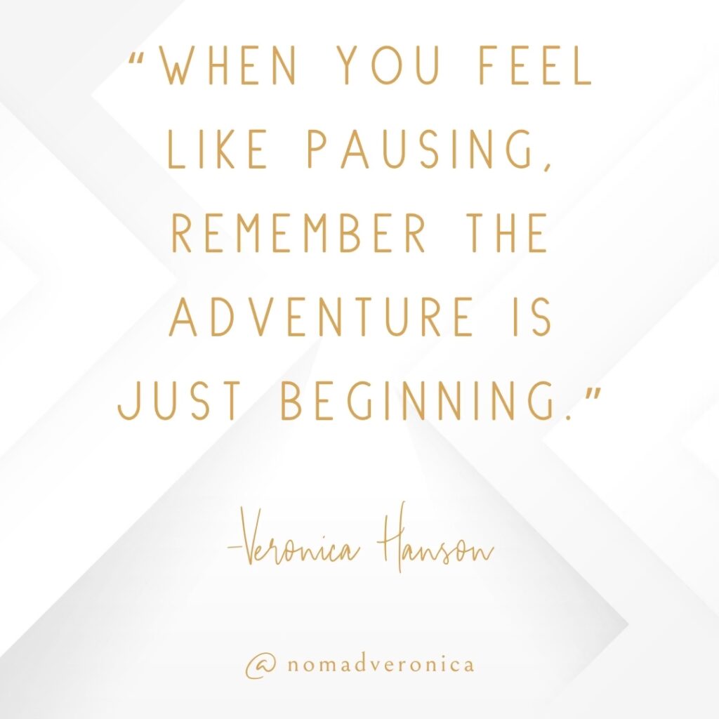 A motivational quote by Veronica Hanson reads, "When you feel like pausing, remember the adventure is just beginning," in refined gold text on a sleek white geometric backdrop. The image also features "@nomadveronica," aligning with themes of resilience and embracing life's ongoing journey.