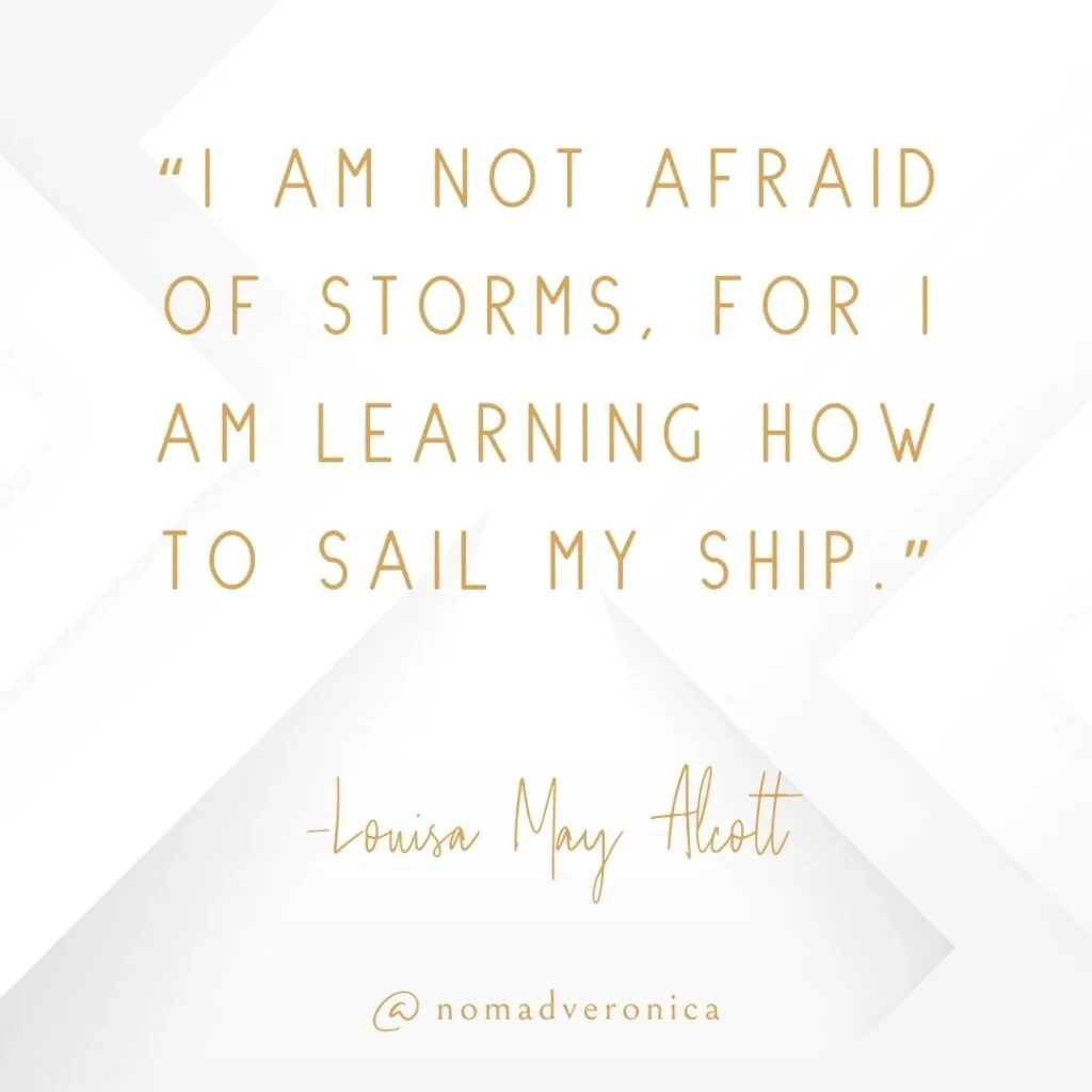 A motivational quote by Louisa May Alcott reads, "I am not afraid of storms, for I am learning how to sail my ship," in gold text on a crisp white geometric background. The design includes the handle "@nomadveronica," emphasizing resilience and personal growth.