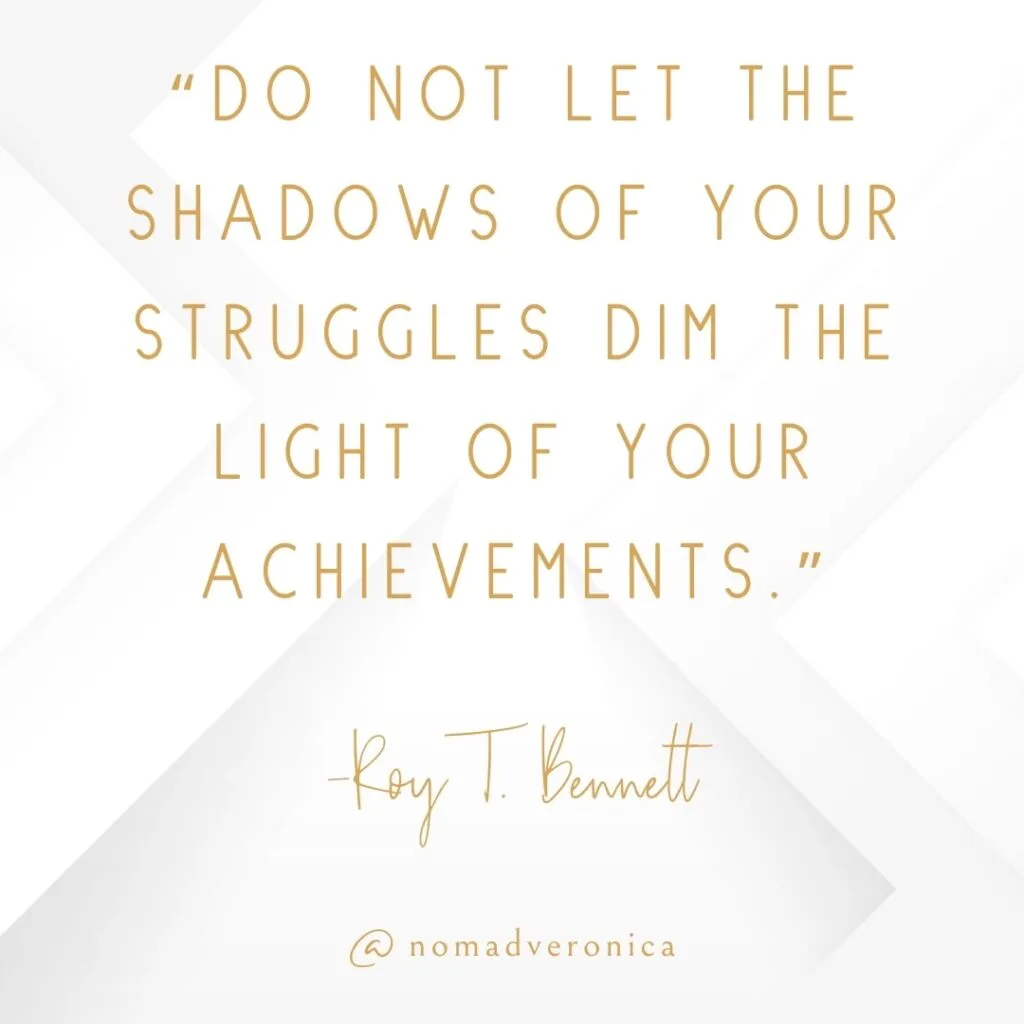 A motivational quote by Roy T. Bennett, "Do not let the shadows of your struggles dim the light of your achievements," is written in gold text on a white geometric background. The design is branded with the handle "@nomadveronica," giving a personal touch to this encouraging and uplifting message.
