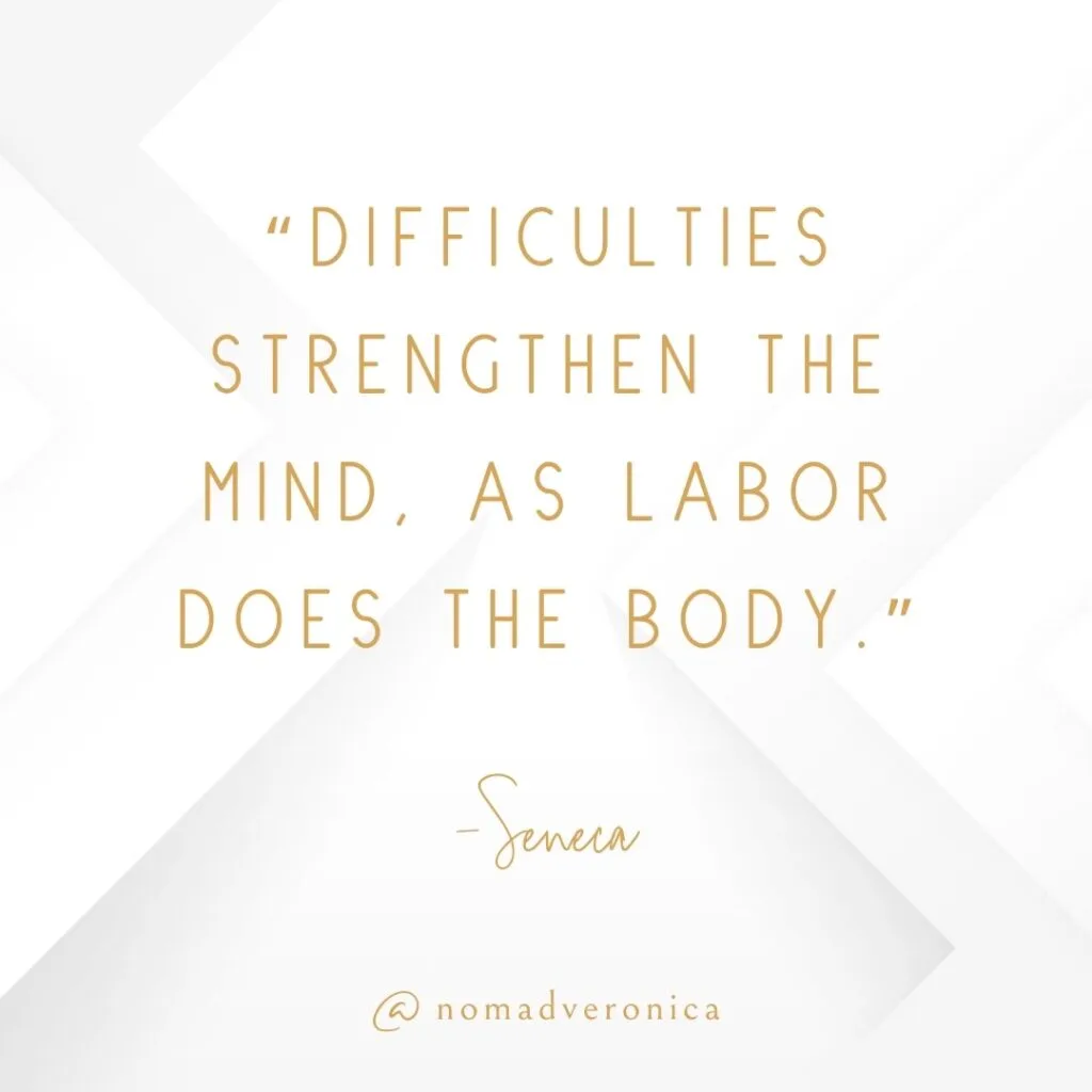 White and gold minimalist graphic displaying the quote 'Difficulties strengthen the mind, as labor does the body' by Seneca, attributed to @nomadveronica. A motivational choice for a section on quotes about embracing new challenges.