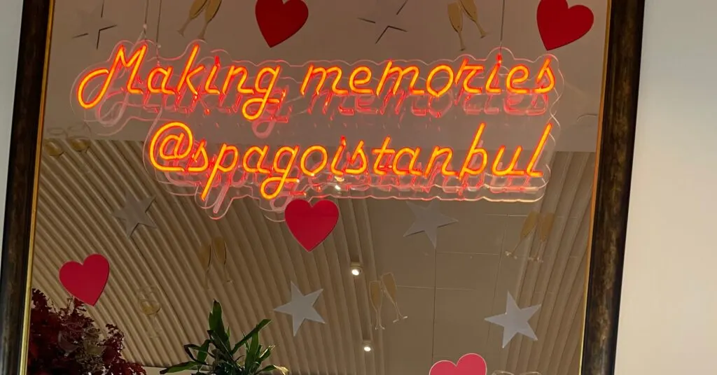 Neon sign reading 'Making memories @spagoistanbul' surrounded by heart and star decorations, showcasing a family-friendly dining experience at a top location when deciding where to stay in Istanbul.