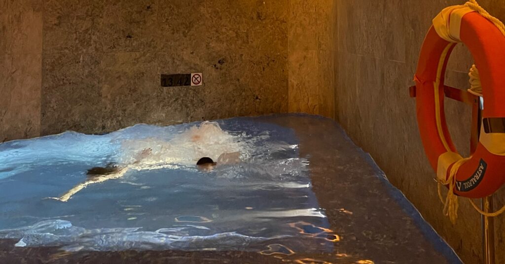 Children swimming in a private indoor pool with marble walls, highlighting the premium facilities available at the best luxury hotels in Istanbul for families.