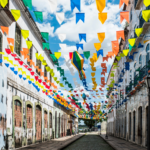 A lively street lined with colonial buildings, adorned with multicolored banners. Experiencing Brazil’s festivals and traditions is a highlight for those moving to Brazil from the US.