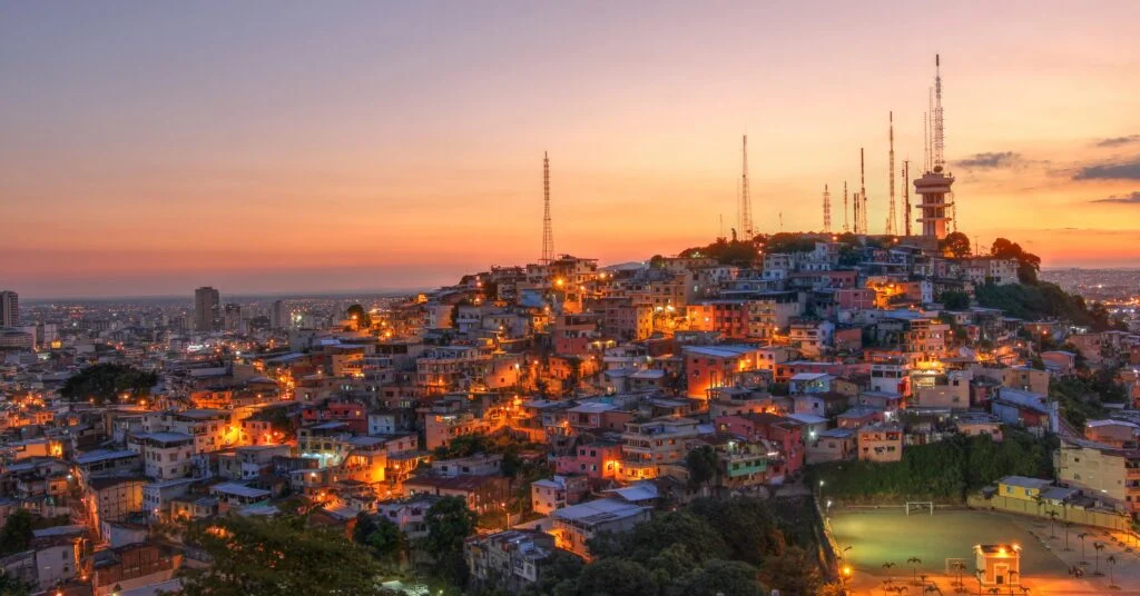 A scenic shot of Quito, Ecuador, highlighting colorful colonial buildings and the famous Panecillo hill with the Virgin Mary statue. Many Ecuador expats call this vibrant city home.