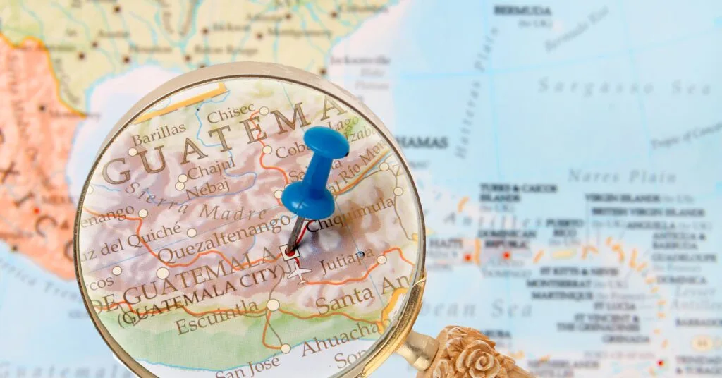 A close-up of a Portugal map with a small flag pinned on the capital, Lisbon. Perfect for anyone thinking of moving to Portugal and planning their next big adventure.