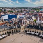 Aerial view of Dijon’s historic center with traditional rooftops and a wide city square, a popular region for expats moving to France