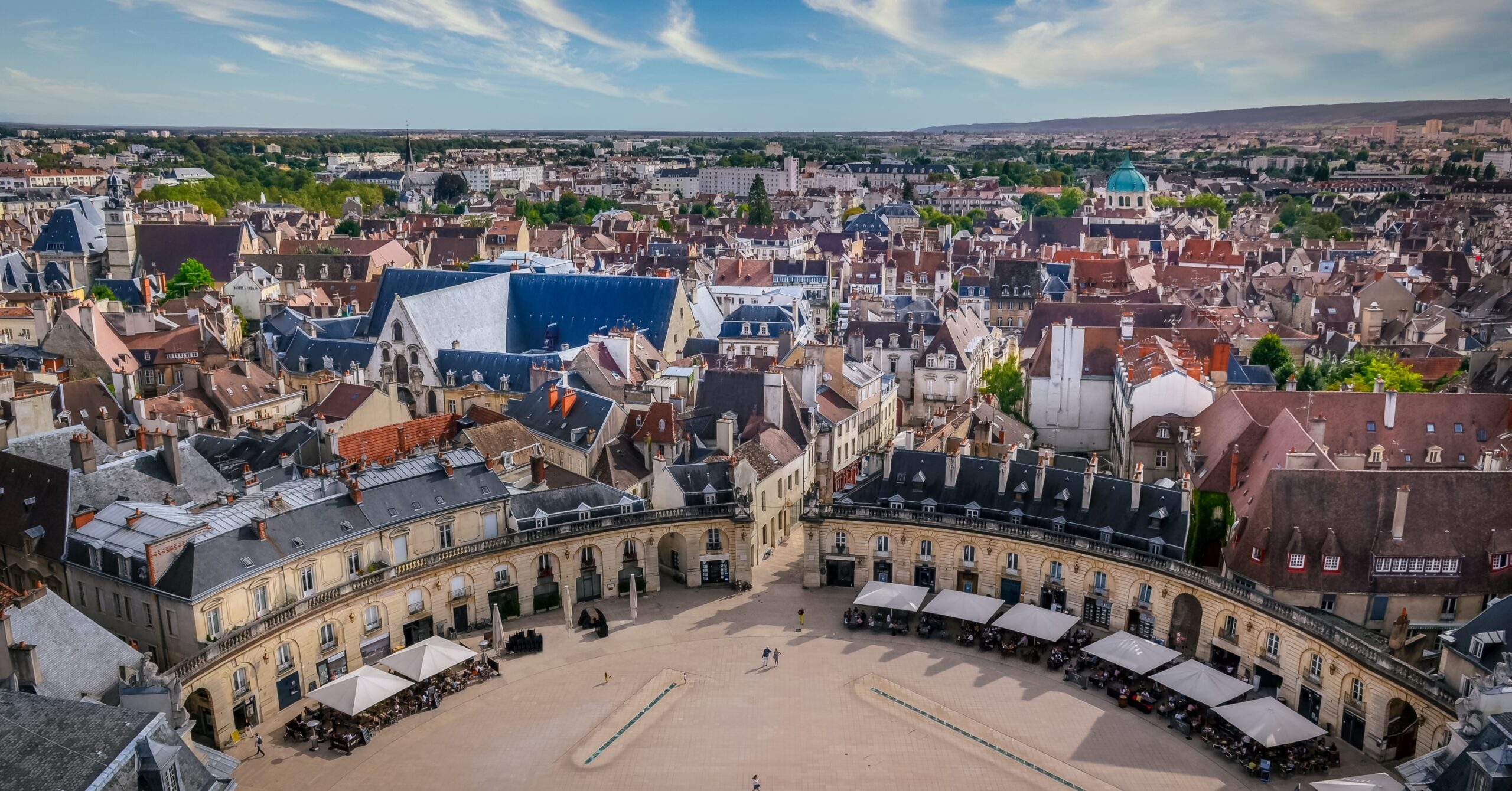 Aerial view of Dijon’s historic center with traditional rooftops and a wide city square, a popular region for expats moving to France