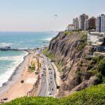Coastal cityscape of Lima, a common destination for those moving to Peru seeking city life.