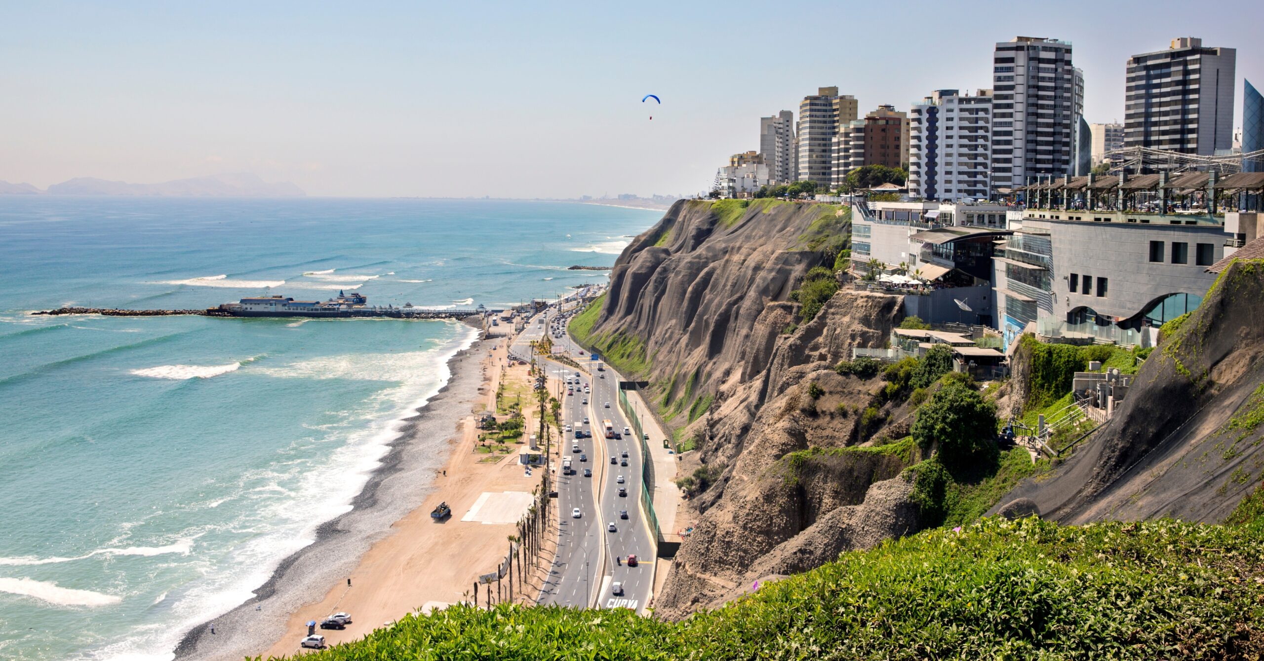 Coastal cityscape of Lima, a common destination for those moving to Peru seeking city life.