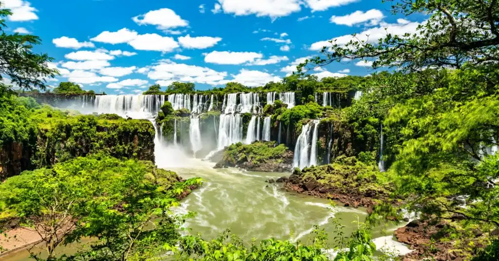 The powerful Iguazú Falls cascading across lush cliffs, offering breathtaking natural beauty often explored by expats after moving to Argentina.